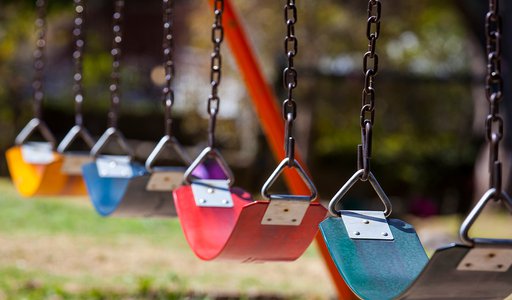 empty colorful swings at the park